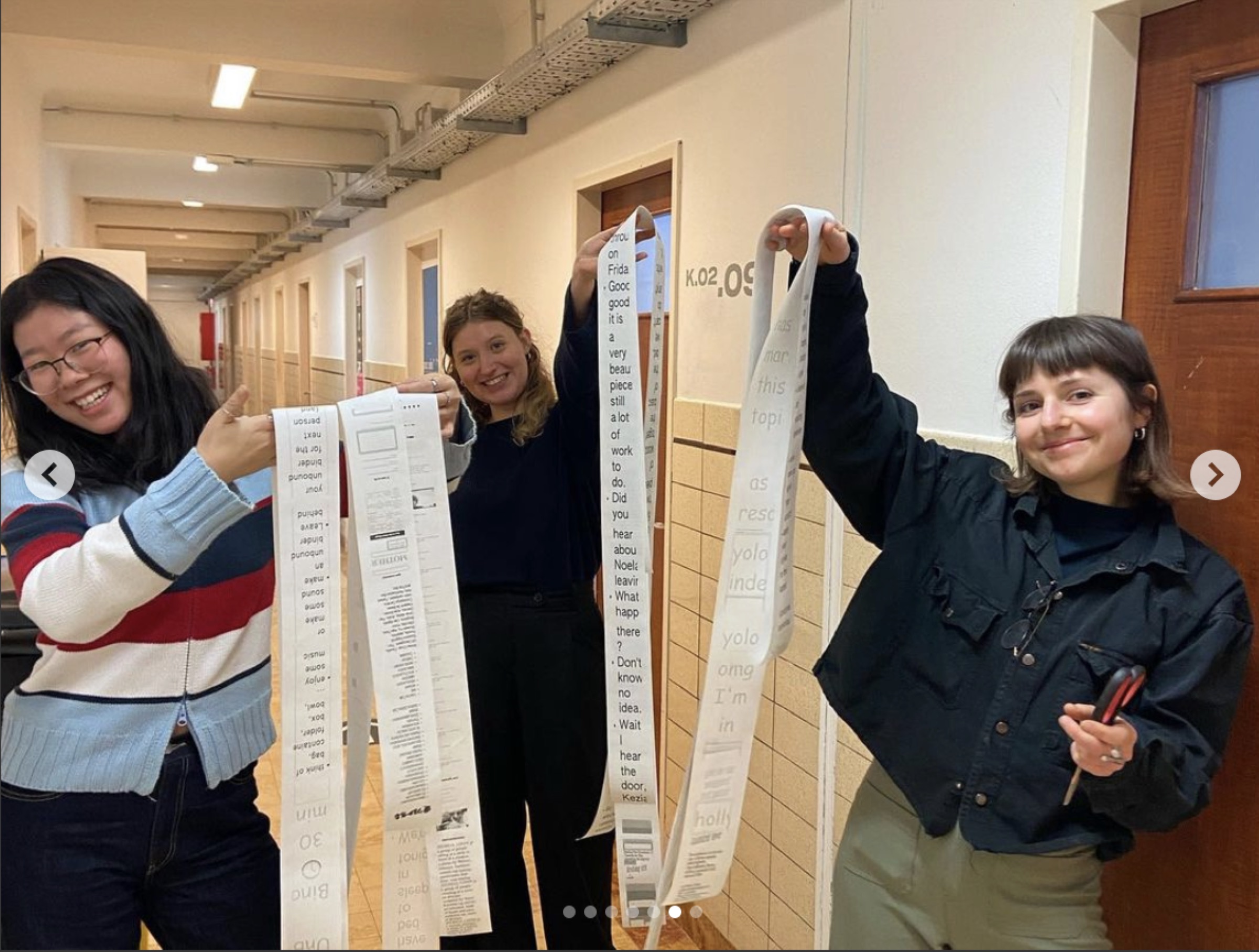 Students proudly showing their thermal-printed zines in the hallway